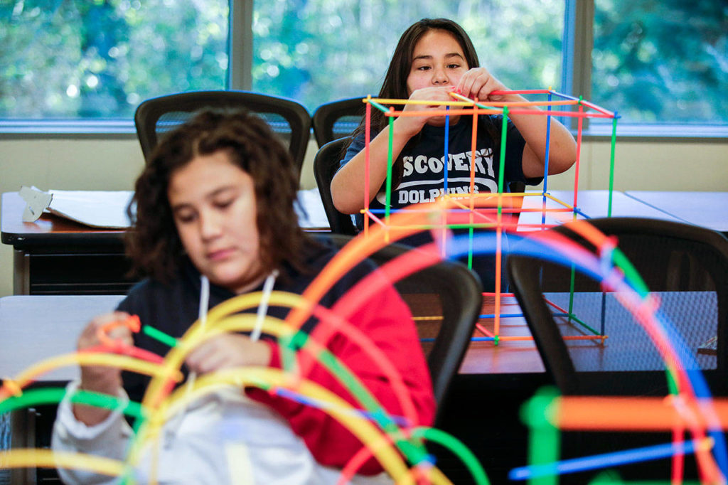 Brittany Galeana build a veterinary building out of straws as her brother Robert works on his arched building Saturday, Nov. 17, as part of the Parent Leadership Training Institute and the Children’s Leadership Institute in Everett. (Andy Bronson / The Herald)
