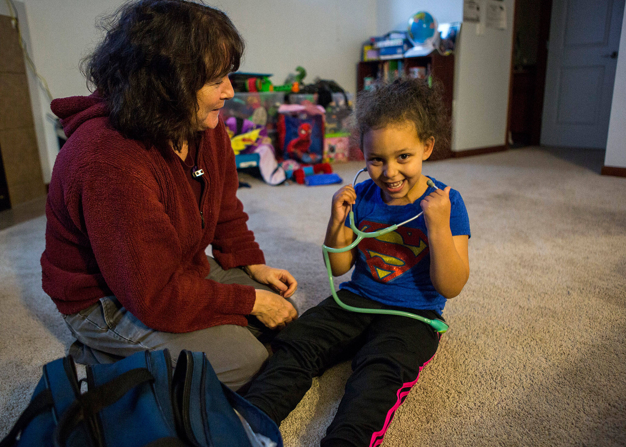 Providence Hospice and Home Care of Snohomish County nurse Pam Crayne-Smith allows Kaya Sanders, 5, to listen to her own heartbeat during a weekly checkup at the girl’s Everett home. (Olivia Vanni / The Herald)