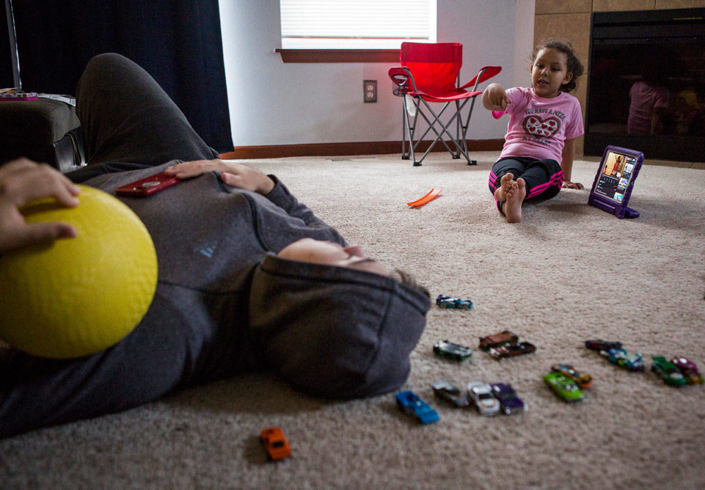 Before getting ready for school Thursday, Kaya hangs out with her brother, Chance. (Olivia Vanni / The Herald)
