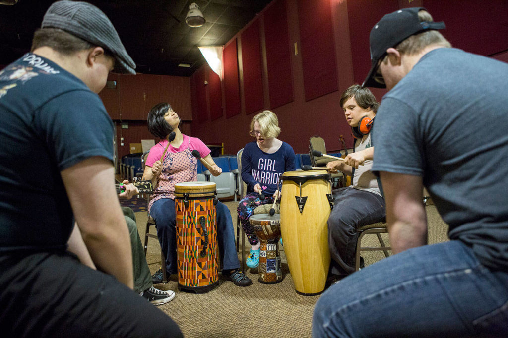 Maya Bristol (left), Amanda Winsor (center) and Anthony Moore play the drums during a Music YoU-ROCK program at the Northwest Music Hall in Everett. (Olivia Vanni / The Herald) 
