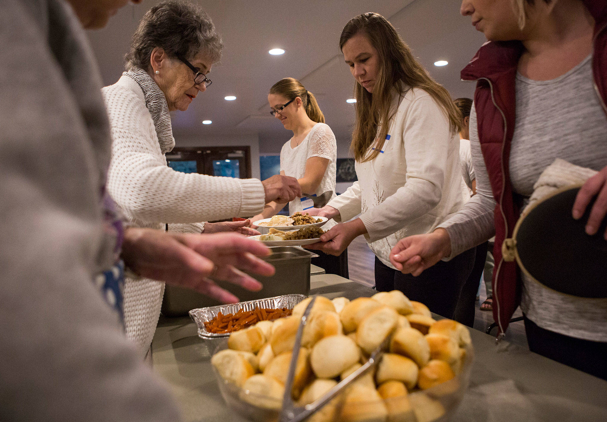 Michelle Clark gets a plate filled during the Eagle Wings disAbility Ministries Thanksgiving dinner at Warm Beach Free Methodist Church in Stanwood. (Olivia Vanni / The Herald)