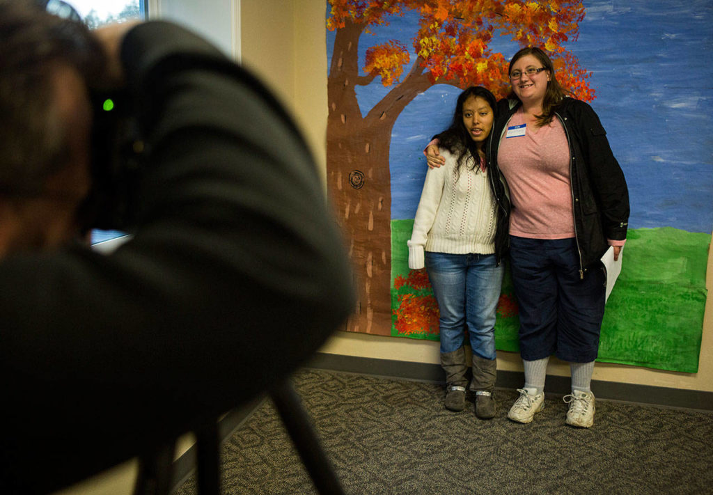 Cece Jimenez (left) and Brittany Smolinski pose for a photo during the Eagle Wings disAbility Ministries Thanksgiving dinner at Warm Beach Free Methodist Church in Stanwood. (Olivia Vanni / The Herald) 

