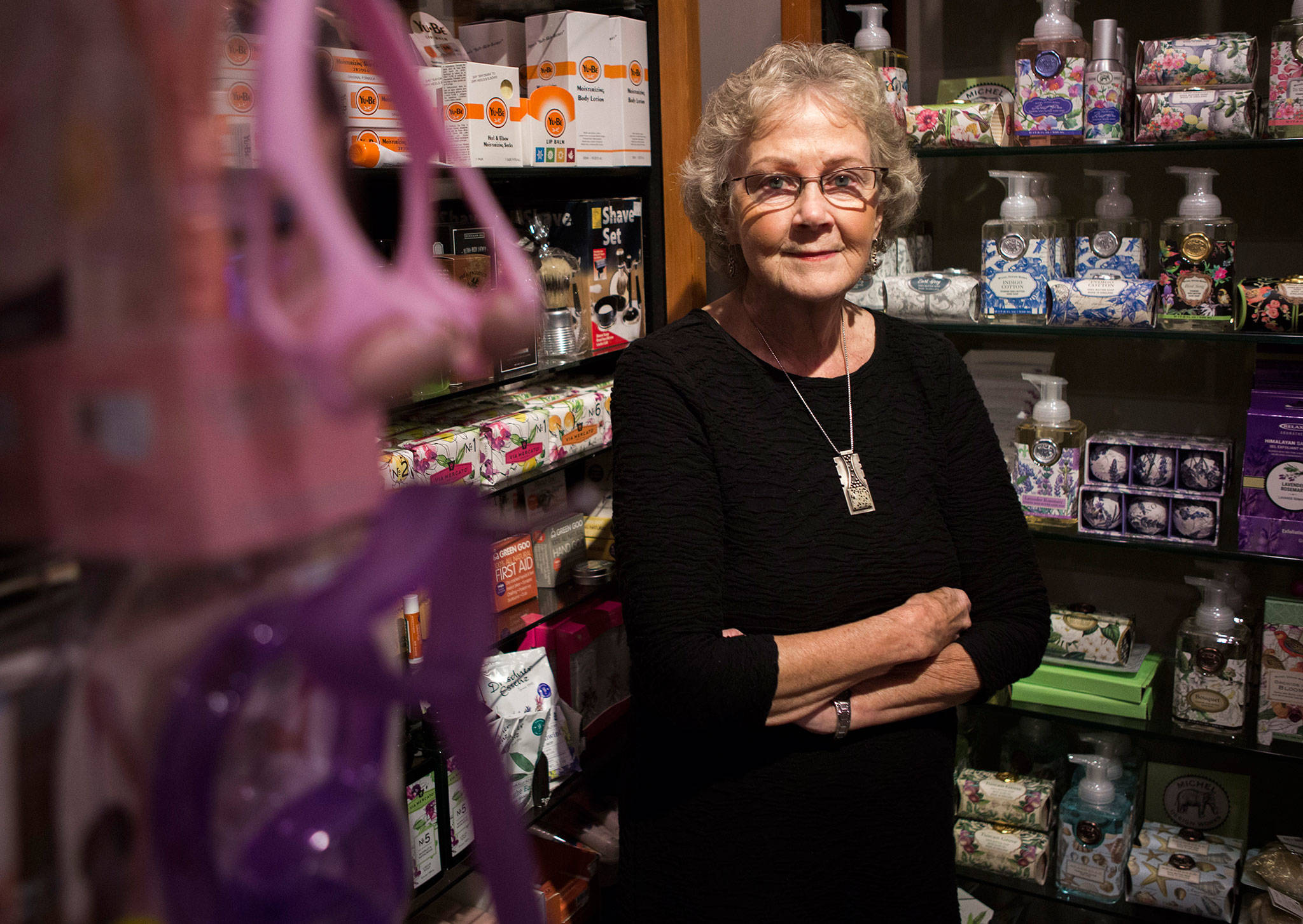 Judy Matheson, owner of J. Matheson Gifts, Kitchen & Gourmet in Everett, with some of the hundreds of products she carries that will be effected by tariffs. (Olivia Vanni / The Herald)