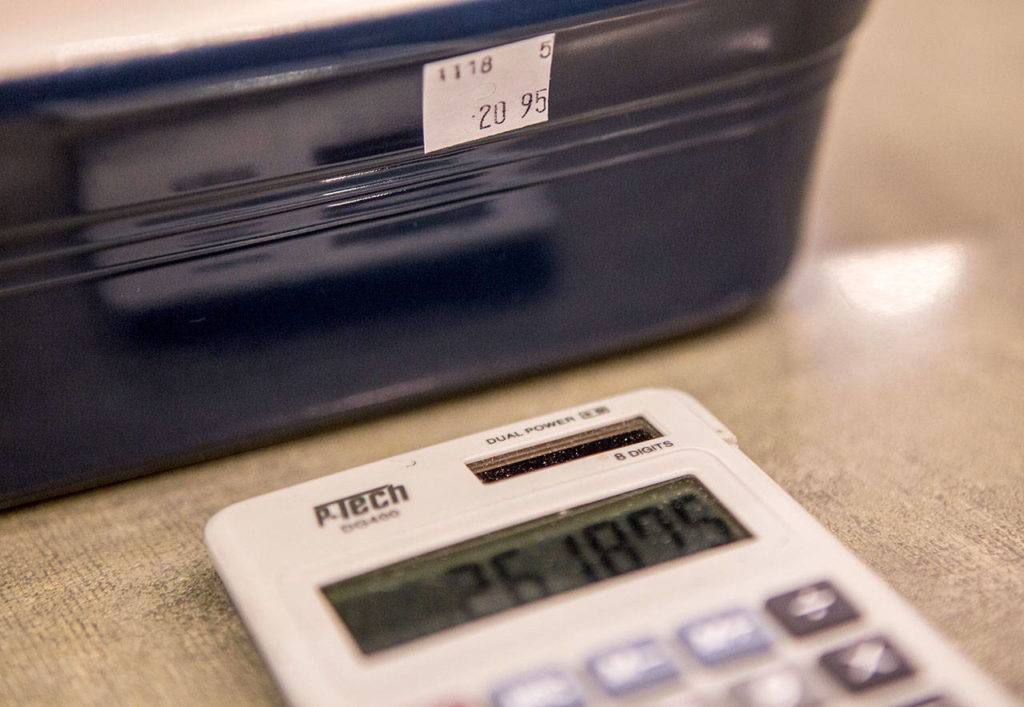 A calculator at J. Matheson Gifts in Everett displays the possible price for this dish after new tariffs take effect. (Olivia Vanni / The Herald)
