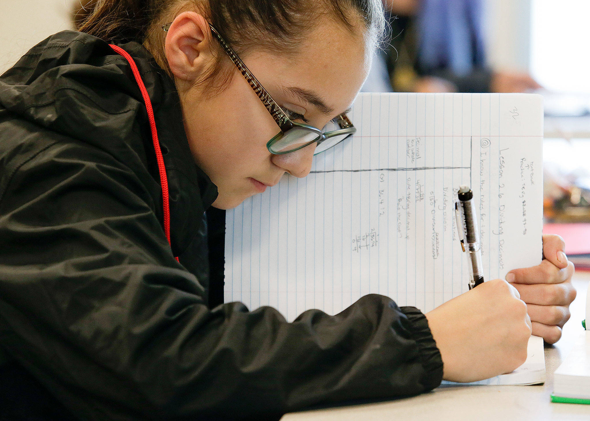 Brooklyn Flores works on homework at the Learning Labs at Olympic View Middle School, a free after-school program for sixth-graders to get an academic boost. Volunteer tutors range from high school students to retirees. (Andy Bronson / The Herald)