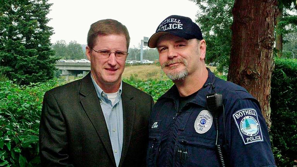 Patrick Arpin (left), an assistant police chief in Bellevue, and Bothell police officer Jon Caban rescued a young person from a highway overpass. (Contributed photo)

