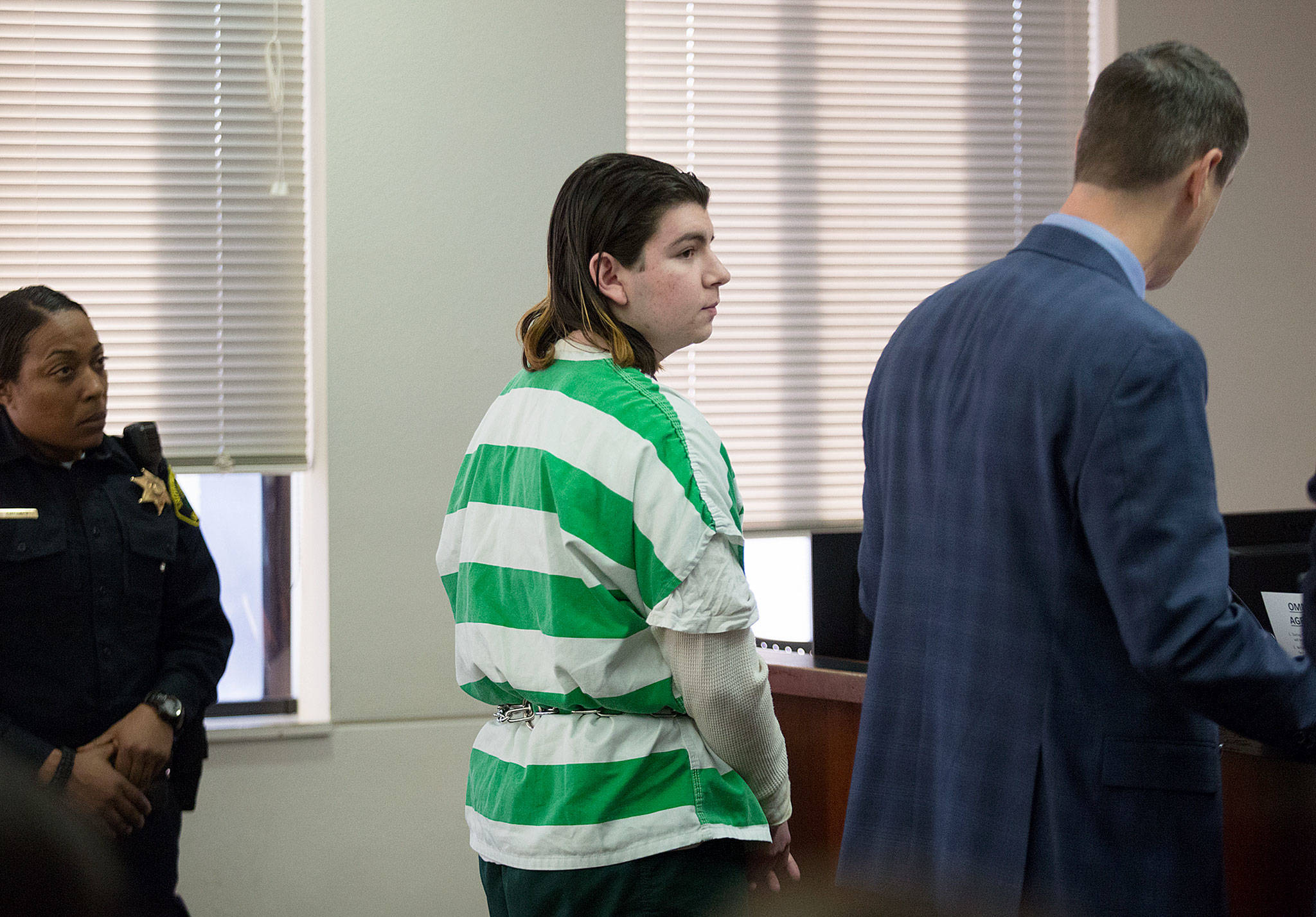 Joshua O’Connor listens to his attorney, before pleading guilty to charges that he plotted a school shooting, at the Snohomish County Courthouse on Thursday, Dec. 6, in Everett. (Andy Bronson / The Herald)