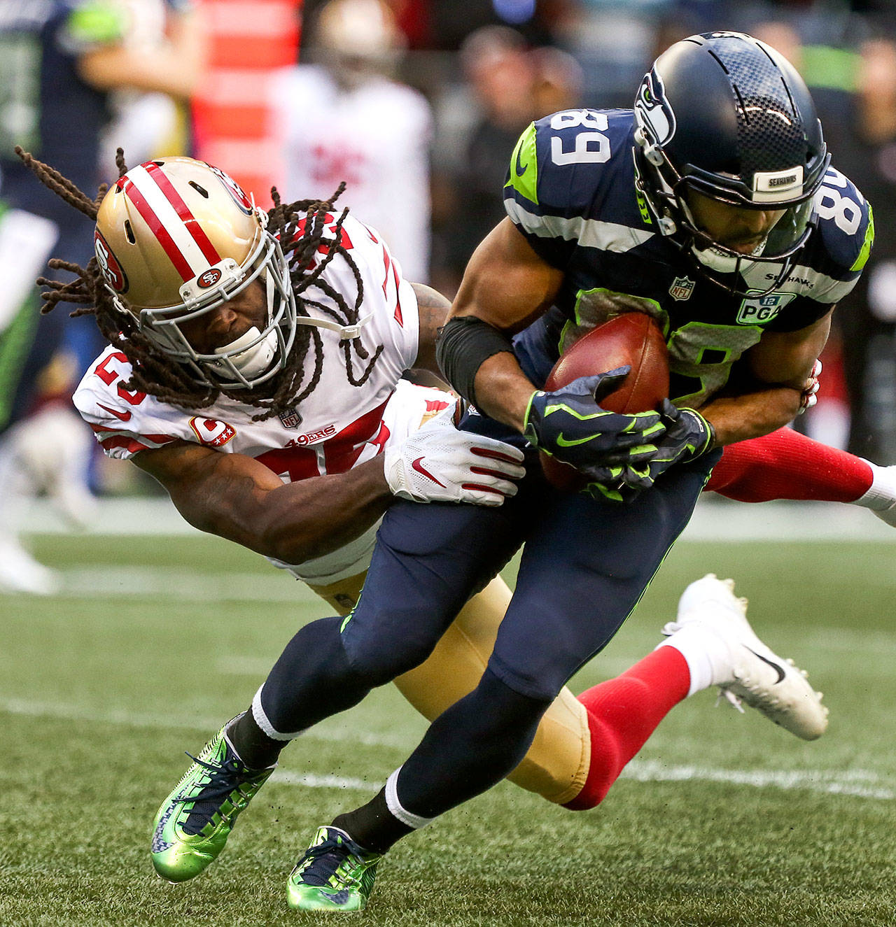 Seahawks wide receiver Doug Baldwin slips a tackle attempt by 49ers cornerback Richard Sherman during Sunday’s game at CenturyLink Field in Seattle. (Kevin Clark/The Herald)
