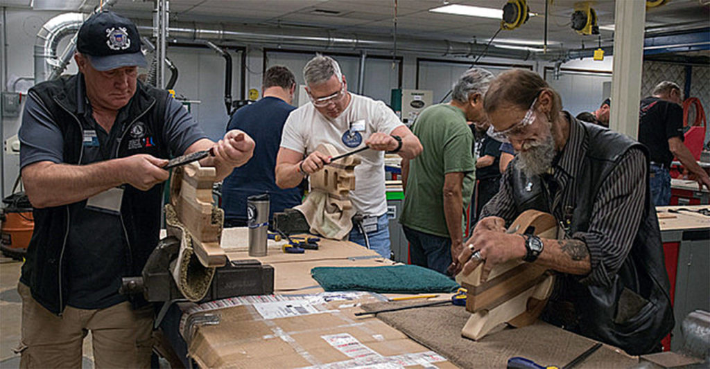 Andre Turner (from left), Chris Szarek and Joseph Walton build guitars at a workshop hosted by Edmonds Community College in November in recognition of Veterans Day. (Photo by James Huntington Cordero)
