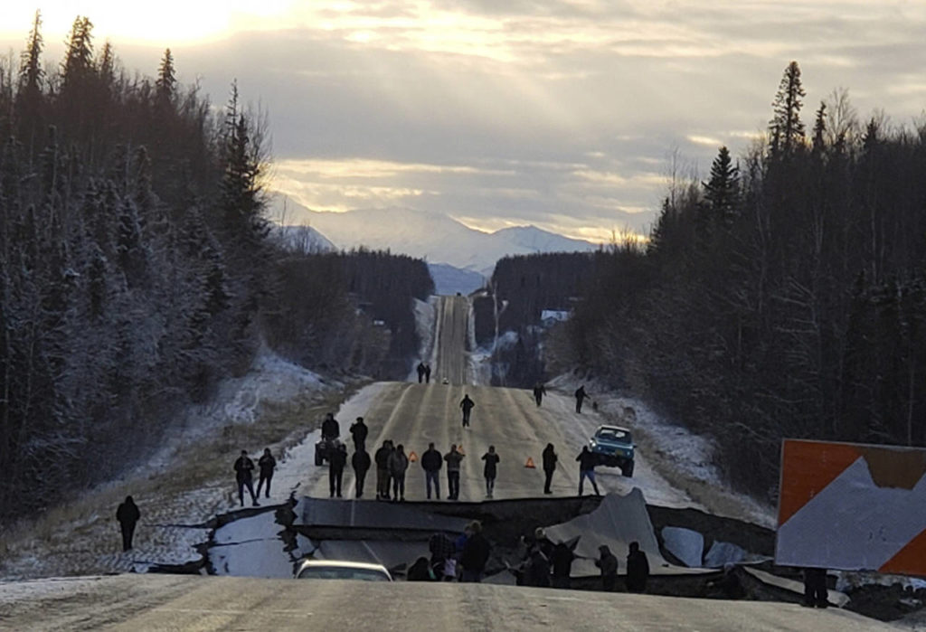 People walk along Vine Road after an earthquake Friday in Wasilla, Alaska. (Jonathan M. Lettow via AP)
