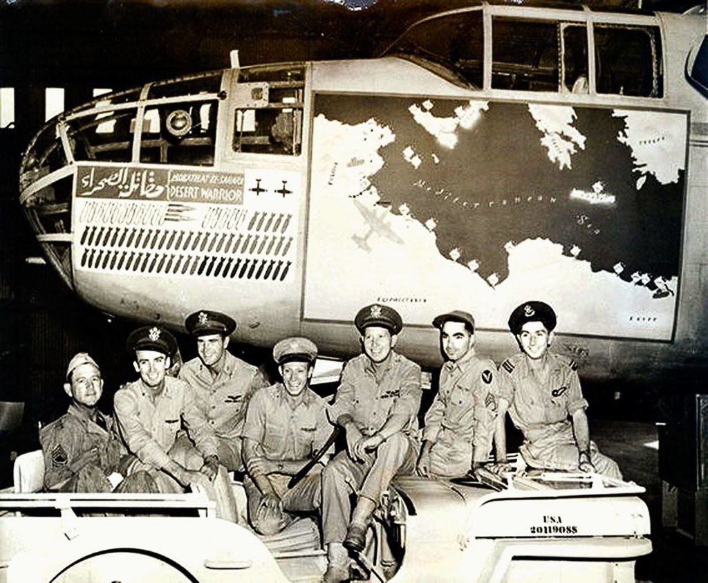 Everett’s Ralph Lower (third from left) was captain of the “Desert Warrior,” a Mitchell B-25 bomber shown with crew members in this photo after flying historic missions in North Africa during World War II. Bombs painted on the plane represent its missions, and the map shows sites it bombed. Lower died Nov. 24 at age 99. (U.S. Signal Corps photo / MacArthur Museum of Arkansas Military History)
