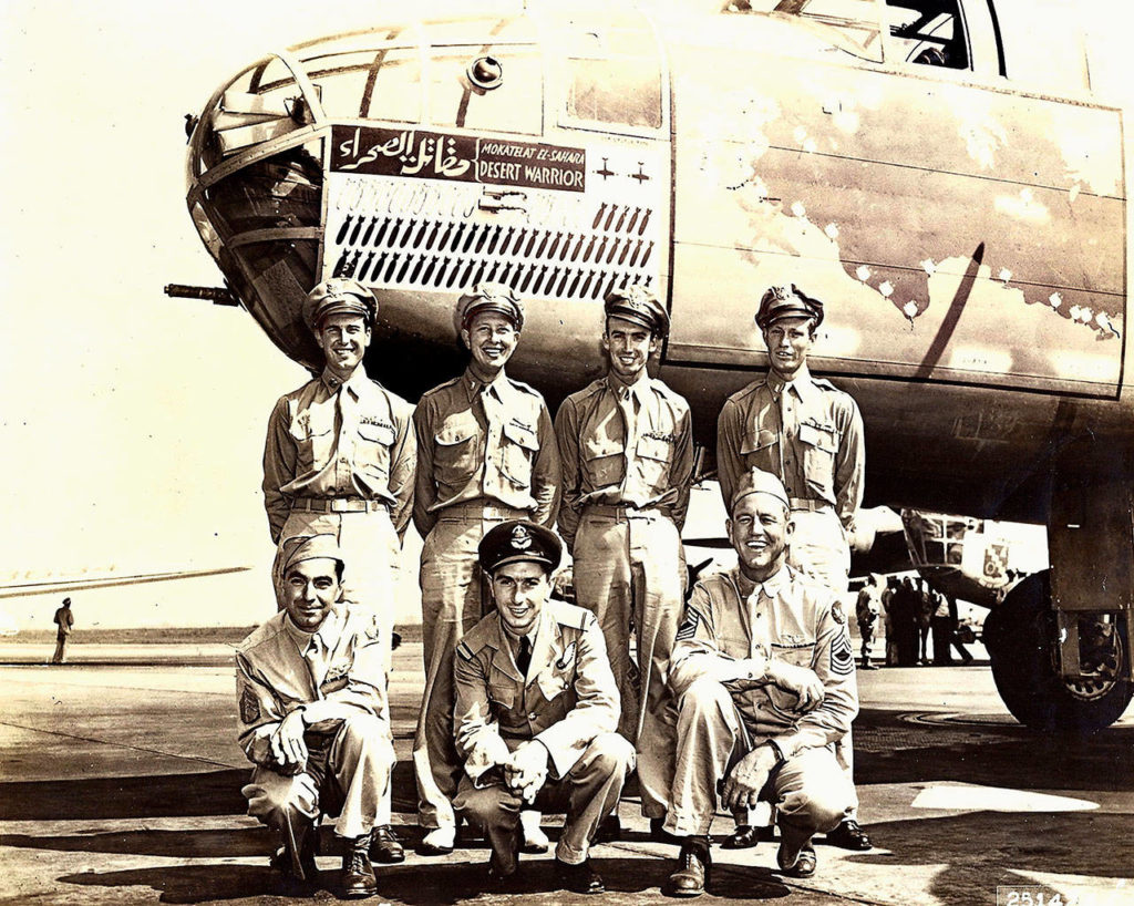 Everett’s Ralph Lower (back row, far left) is shown with the “Desert Warrior” Mitchell B-25 bomber he piloted in North Africa during World War II as part of the U.S. Army 9th Air Force. After flying 52 missions, Lower toured the United States in the plane to promote the sale of war bonds. He died Nov. 24 at age 99. (Photo Courtesy of the Raguso family)
