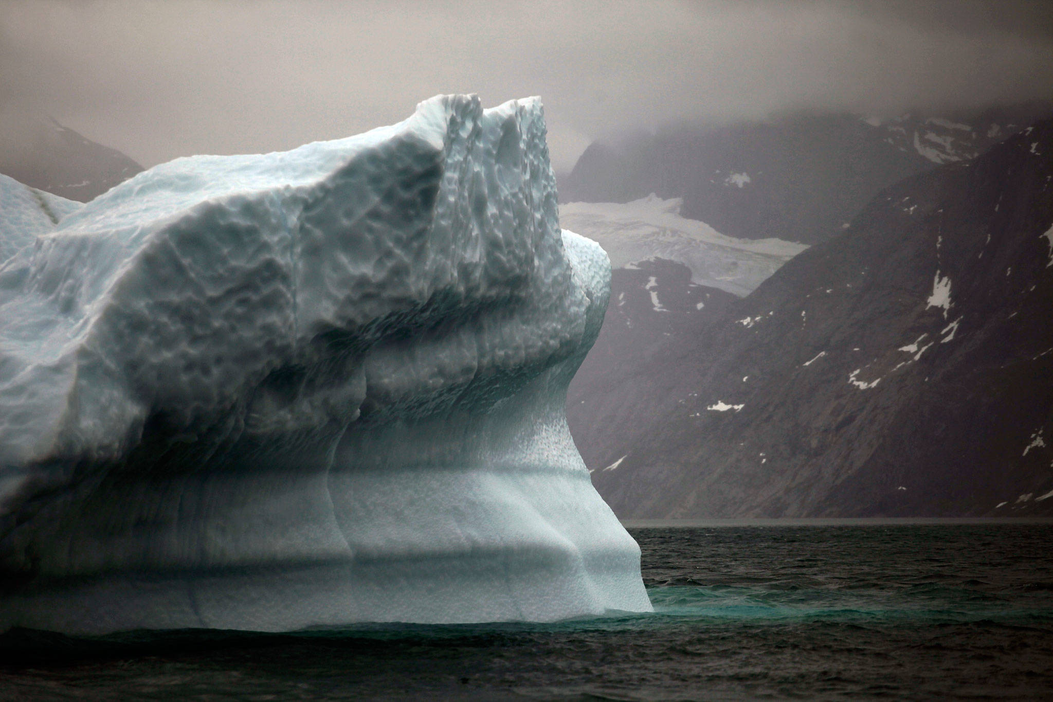 A melting iceberg floats along a fjord leading away from the edge of the Greenland ice sheet near Nuuk, Greenland, in July, 2011. Massive ice sheets in western Antarctica and Greenland are melting much faster than scientists figured a quarter century ago. Greenland has lost more than 5 trillion tons since 1992. (Associated Press file photo)