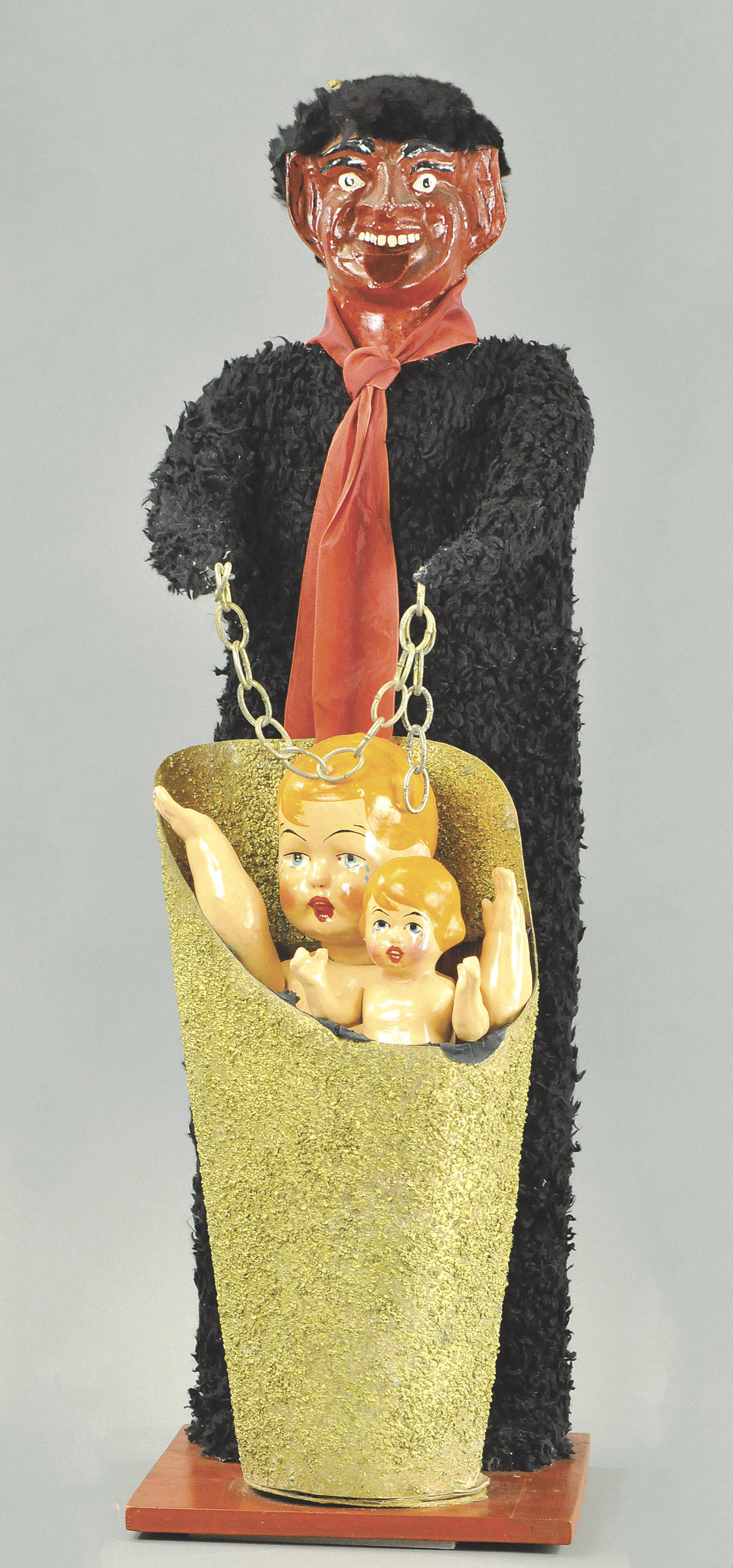 Christmas celebrations were very different centuries ago. There was a gift-giving Santa and a devil punishing children, drunken men chasing people, and coal for bad children. Krampus, this strange man, was to be feared. He took bad children away. This figure is a 19th century version of the horned devil. He sold for $1,600. (Cowles Syndicate Inc.)