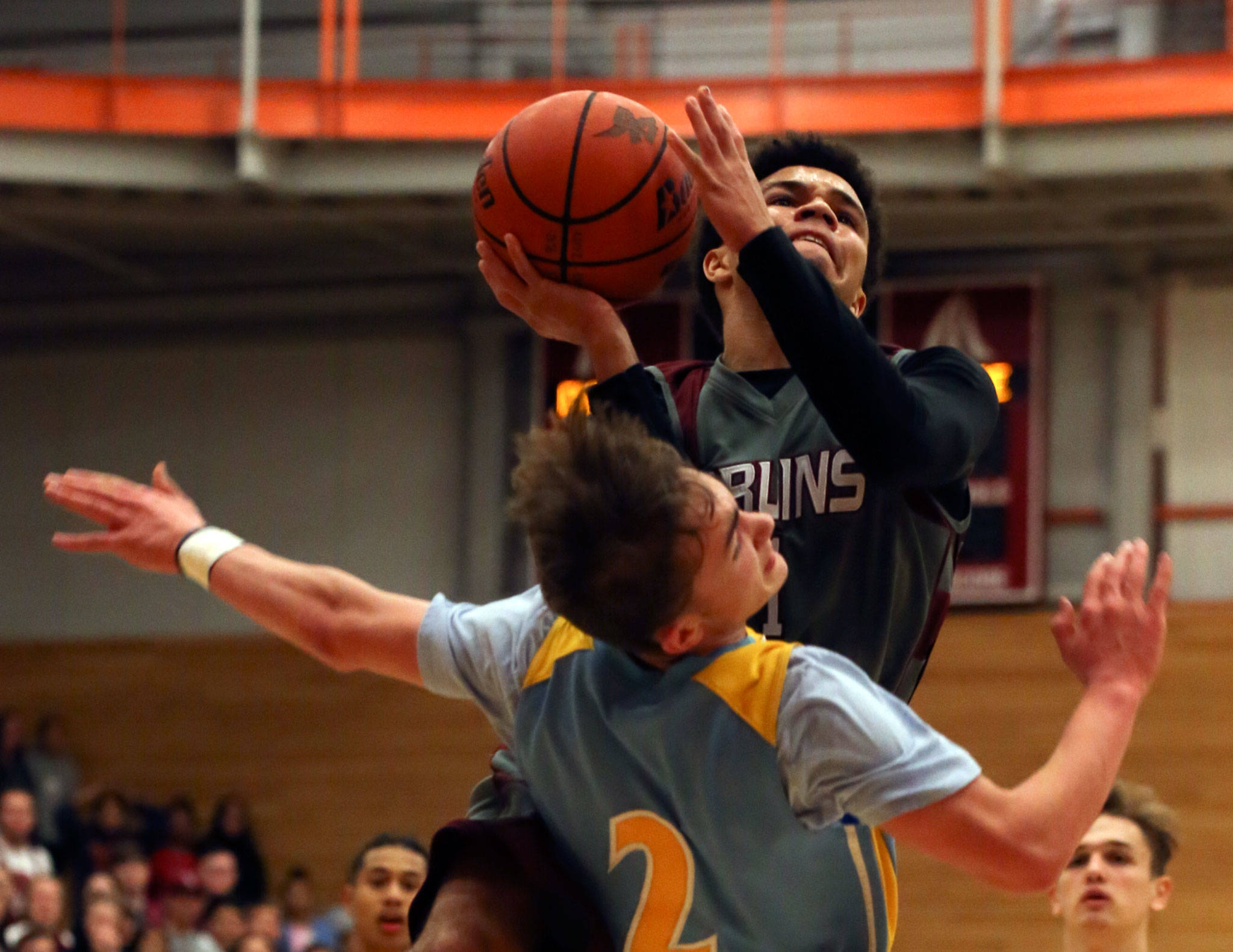 Everett’s Taras Fesiienko (bottom) takes a charge on a drive by Cascade’s Cascade’s Davanta Murphy-McMillan during the annual BruGull Fest game between the cross-town rivals Friday at the Walt Price Student Fitness Center at Everett Community College. (Kevin Clark / The Herald)