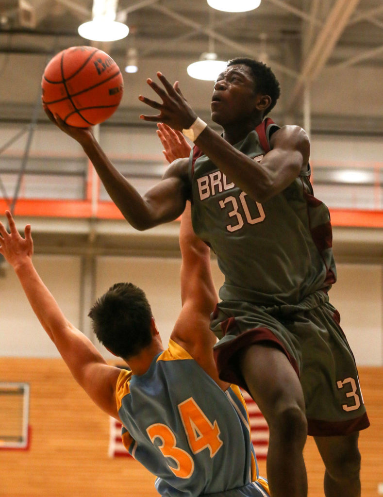 Cascade’s Yahcub Sylla goes up for a shot Friday night during the annual BruGull Fest game against Everett on Friday at the Walt Price Student Fitness Center at Everett Community College Fitness Center. Sylla and the Bruins beat the Seagulls 57-37. (Kevin Clark / The Herald)
