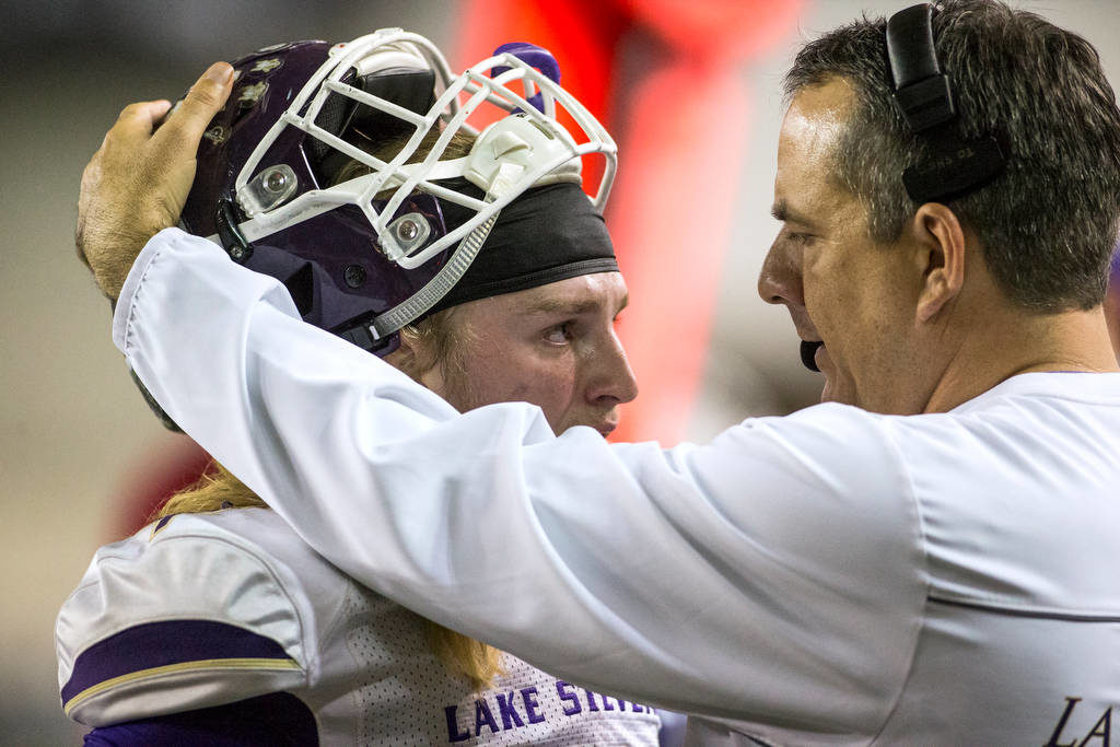 Lake Stevens head coach Thomas Tri consoles quarterback Tre Long near the end of the game as the Vikings lost to Union 52-20 in Washington Div. 4A high school football championship, Saturday, Dec. 1, 2018, in Tacoma, Wash. (Andy Bronson / The Herald via AP)
