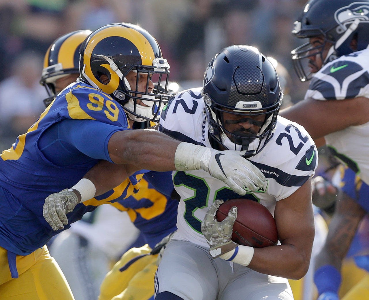 Rams defensive end Aaron Donald (left) tackles Seahawks running back C.J. Prosise during the first half of a game on Nov. 11, 2018, in Los Angeles. (AP Photo/Alex Gallardo)
