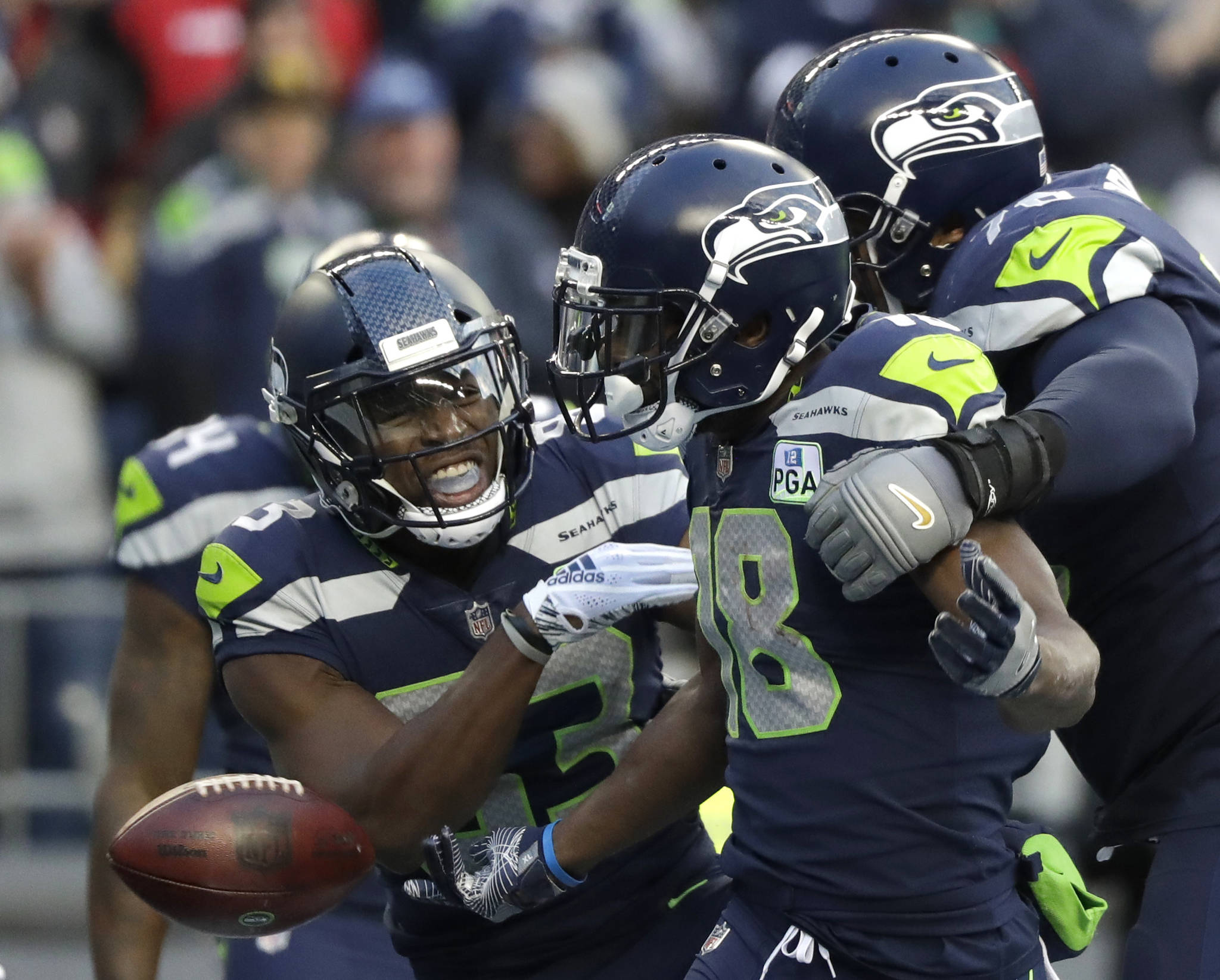 Seattle Seahawks wide receiver Jaron Brown (center) celebrates with wide receiver David Moore (left) and offensive tackle Duane Brown after catching a pass for a touchdown during the second half of Sunday’s game in Seattle. (AP Photo/Elaine Thompson)