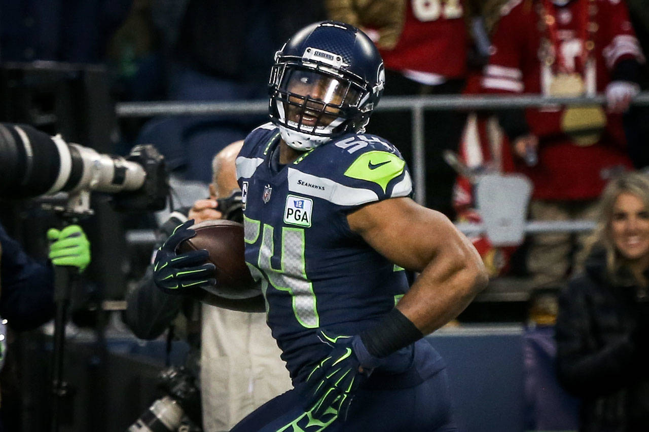 Seahawks linebacker Bobby Wagner returns an interception 98 yards for a touchdown Sunday afternoon at CenturyLink Field. (Kevin Clark / The Herald)