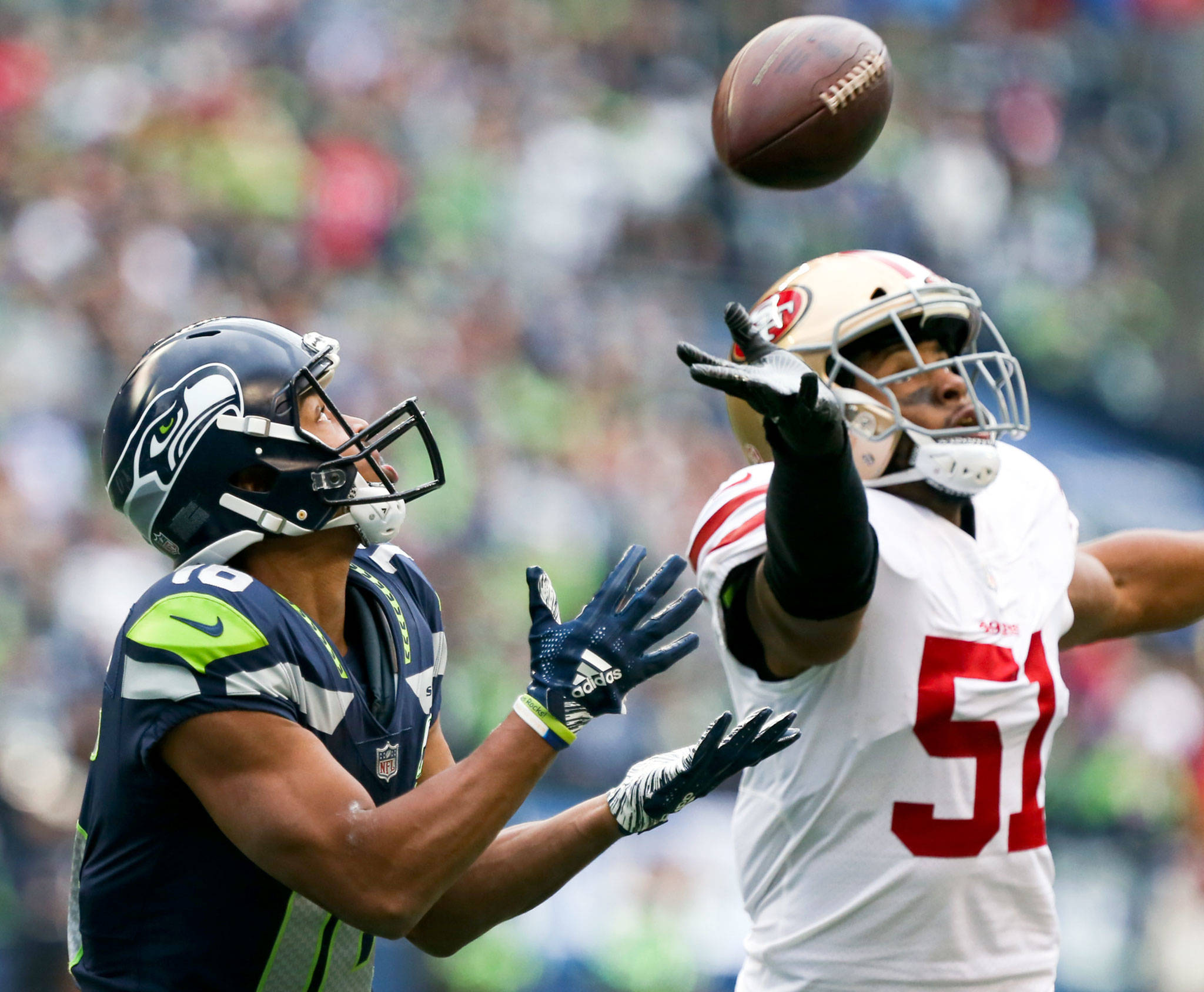 Seahawks wide receiver Tyler Lockett makes a reception en route for a touchdown with 49ers Malcolm Smith defending Sunday afternoon at CenturyLink Field in Seattle on December 2, 2018. Seahawks won 46-16. (Kevin Clark / The Herald)