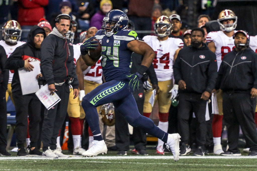 Seahawks linebacker Bobby Wagner returns a 98-yd interception for a touchdown Sunday afternoon at CenturyLink Field in Seattle on December 2, 2018. Seahawks won 46-16. (Kevin Clark / The Herald)
