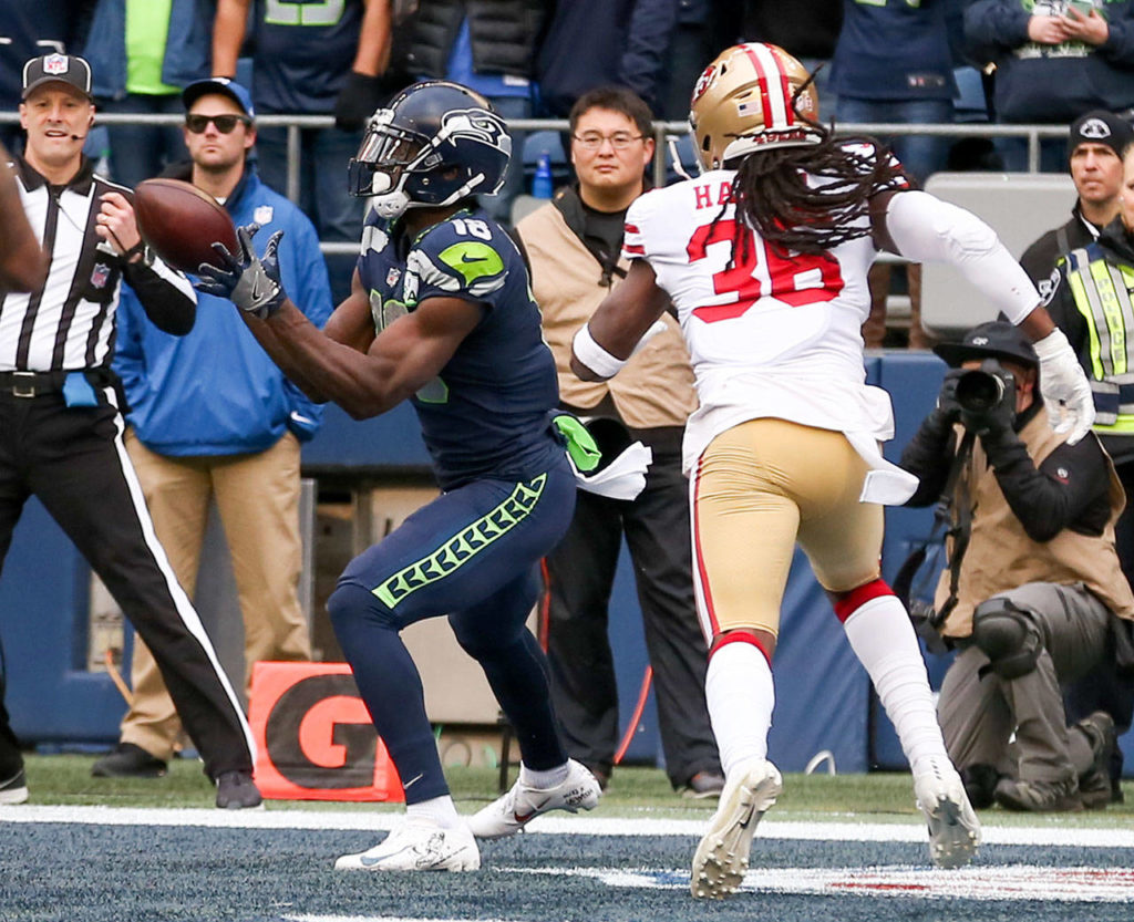 Seahawks wide receiver Jaron Brown makes a touchdown reception with 49ers Marcell Harris closing Sunday afternoon at CenturyLink Field in Seattle on December 2, 2018. Seahawks won 46-16. (Kevin Clark / The Herald)
