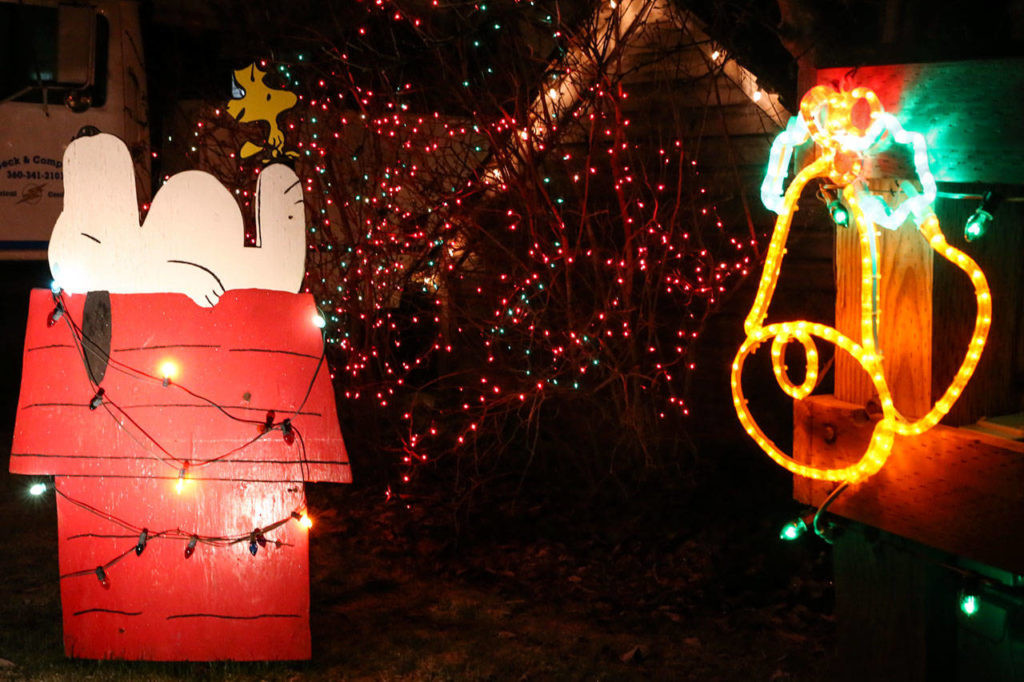 Lois Beck made handmade plywood cutouts of Charlie Brown, Linus and Snoopy for the light show. (Kevin Clark / The Herald)

