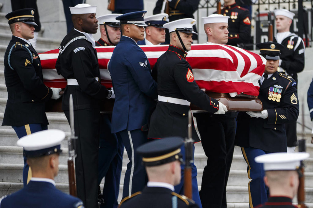The flag-draped casket of former President George H.W. Bush is carried by a joint services military honor guard from the U.S. Capitol on Wednesday in Washington. (Shawn Thew/Pool Photo via AP)
