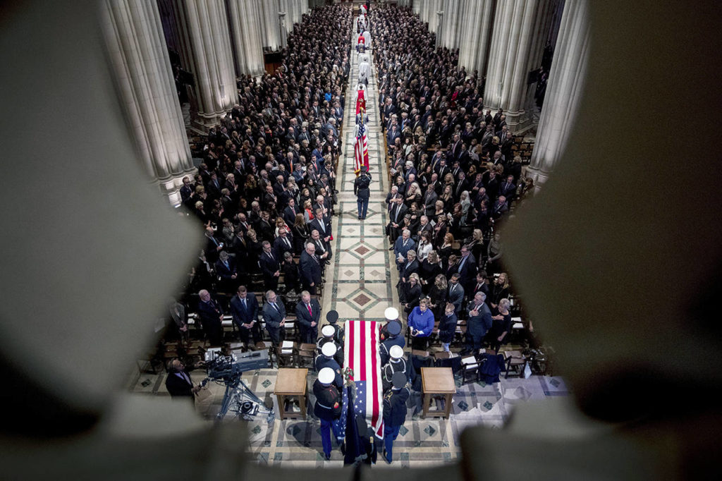 The flag-draped casket of former President George H.W. Bush is carried by a military honor guard during a State Funeral at the National Cathedral on Wednesday in Washington. (AP Photo/Andrew Harnik, Pool)
