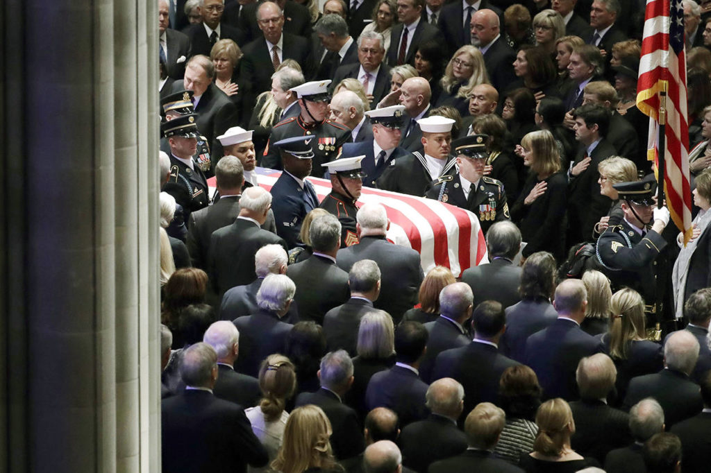 The flag-draped casket of former President George H.W. Bush is carried by a military honor guard during a State Funeral at the National Cathedral on Wednesdayin Washington. (AP Photo/Evan Vucci)
