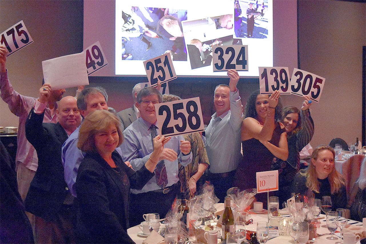 Bidders gathering around their favorite teacher during Fund-A-Need at the Snohomish Education Foundation annual auction. (Contributed photo)