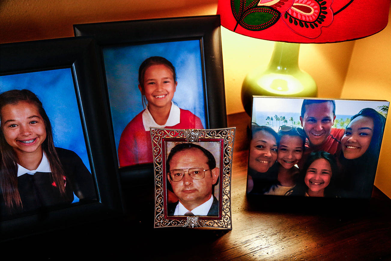 Mayume Carelli’s home is filled with faces of people she loves. Her dad, Dan Varnell (center) was murdered by Gail Brashear in 1996. (Dan Bates / The Herald)