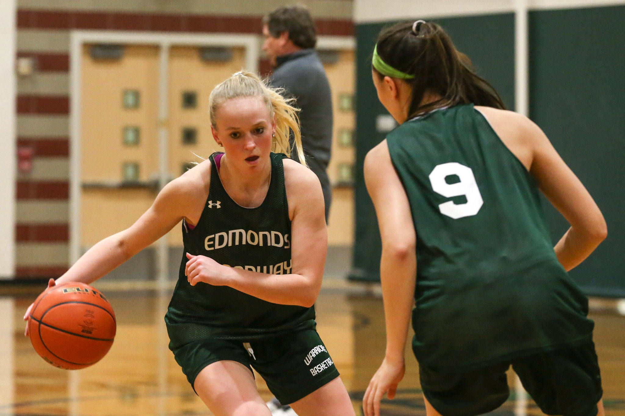 Edmonds-Woodway’s Brooke Kearney (left) runs through a drill with teammate Rebekah Dasalla-Good during a Nov. 28 practice session at Edmonds-Woodway High School. (Kevin Clark / The Herald)