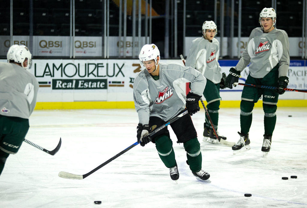 Everett Silvertips players watch as former Vancouver Canucks and Anaheim Ducks defenseman Kevin Bieksa (center) practices at Angel of the Winds Arena on Thursday. (Andy Bronson / The Herald)

