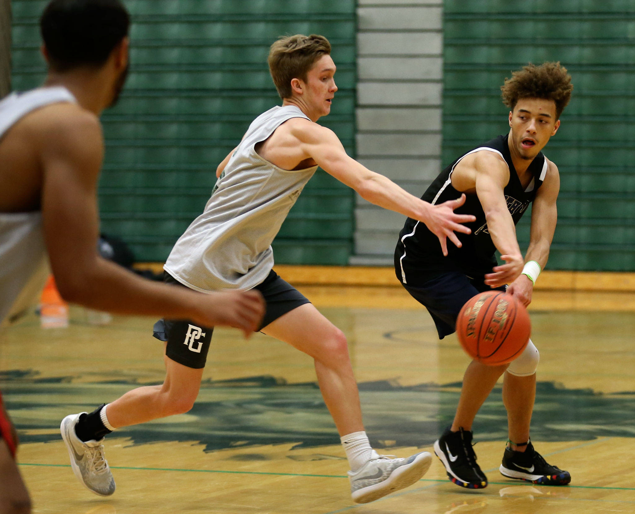 Jackson’s Christian Liddell (right) attempts a pass with Ben Olesen defending during practice on Dec. 6, 2018, at Jackson High School in Mill Creek. (Kevin Clark / The Herald)