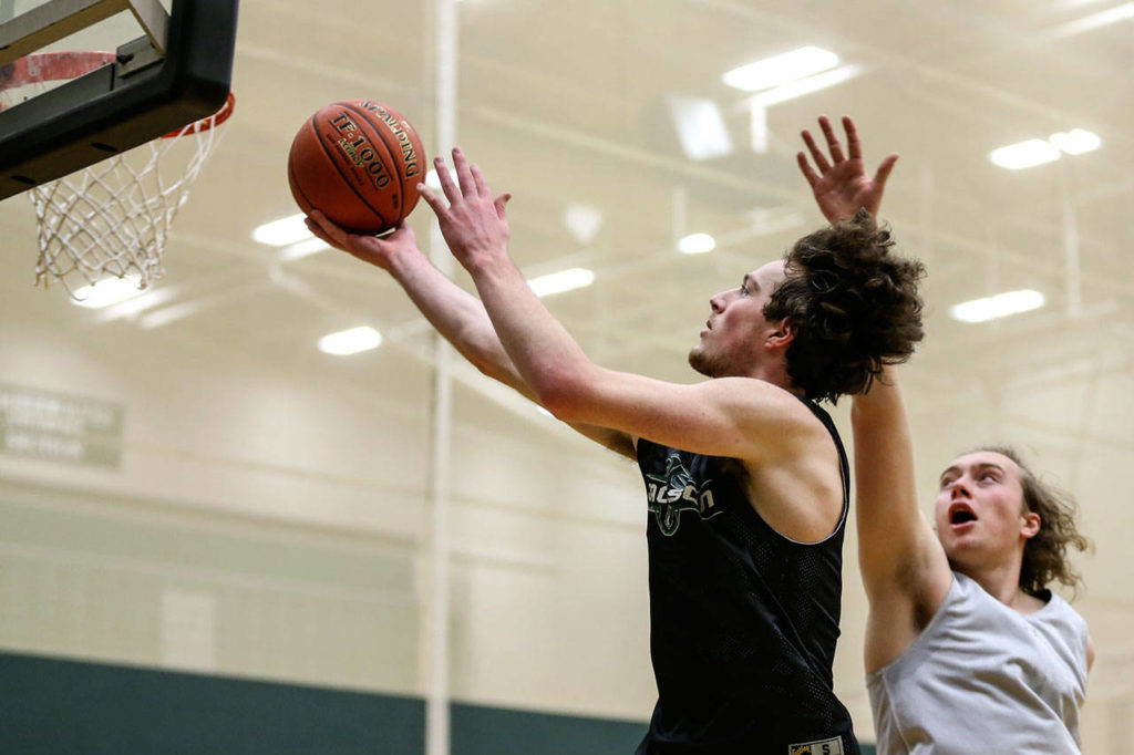 Jackson’s Kyle Bigovich attempts a shot with Joe Capponi defending during practice on Dec. 6, 2018, at Jackson High School in Mill Creek. (Kevin Clark / The Herald)
