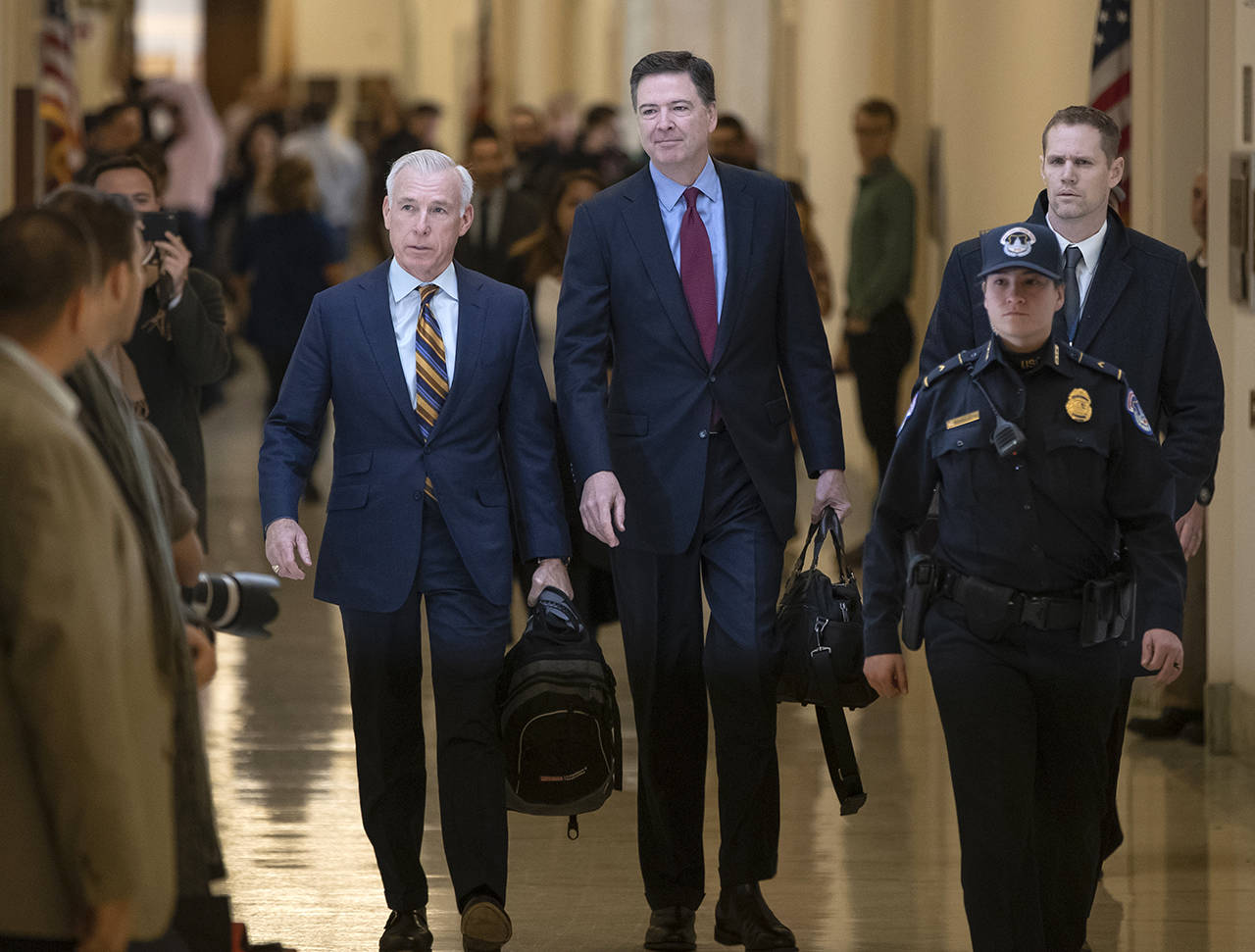 Former FBI Director James Comey and his attorney (David Kelley, left) arrive to testify under subpoena behind closed doors before the House Judiciary and Oversight Committee on Capitol Hill in Washington on Friday. (AP Photo/J. Scott Applewhite)