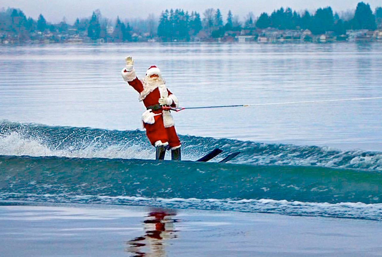 Santa takes a spin around Lake Stevens. The water-skiing Kris Kringle has waved to local residents on Christmas morning each year for 25 years. He’ll be out there again on Tuesday. (Contributed photo)