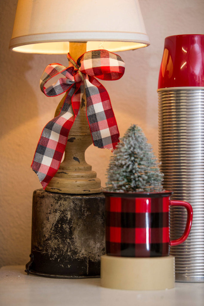 Tying plaid ribbons is an easy way to add holiday cheer to a room. (Andy Bronson / The Herald)
