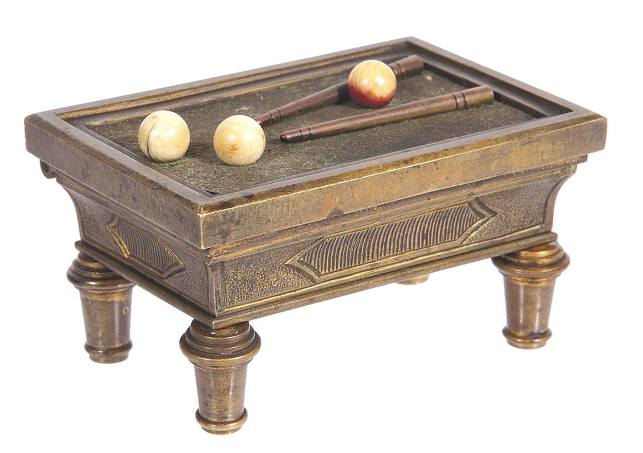This tiny billiard table is actually a box to hold matches. It was kept on a table before it was auctioned by Wm Morford for $834. (Cowles Syndicate Inc.)