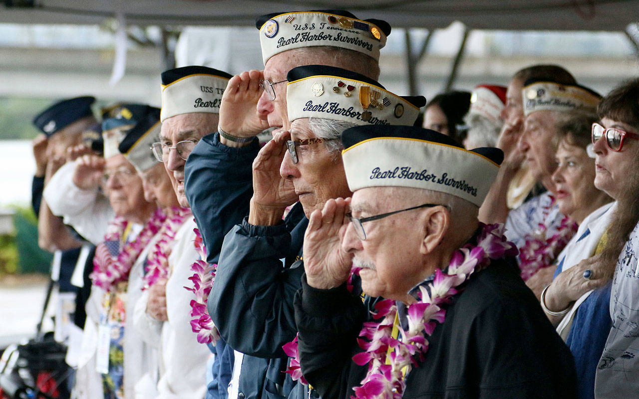 Pearl Harbor survivors salute during at a ceremony in Pearl Harbor, Hawaii, on Friday marking the 77th anniversary of the Japanese attack. (Audrey McAvoy / Associated Press)