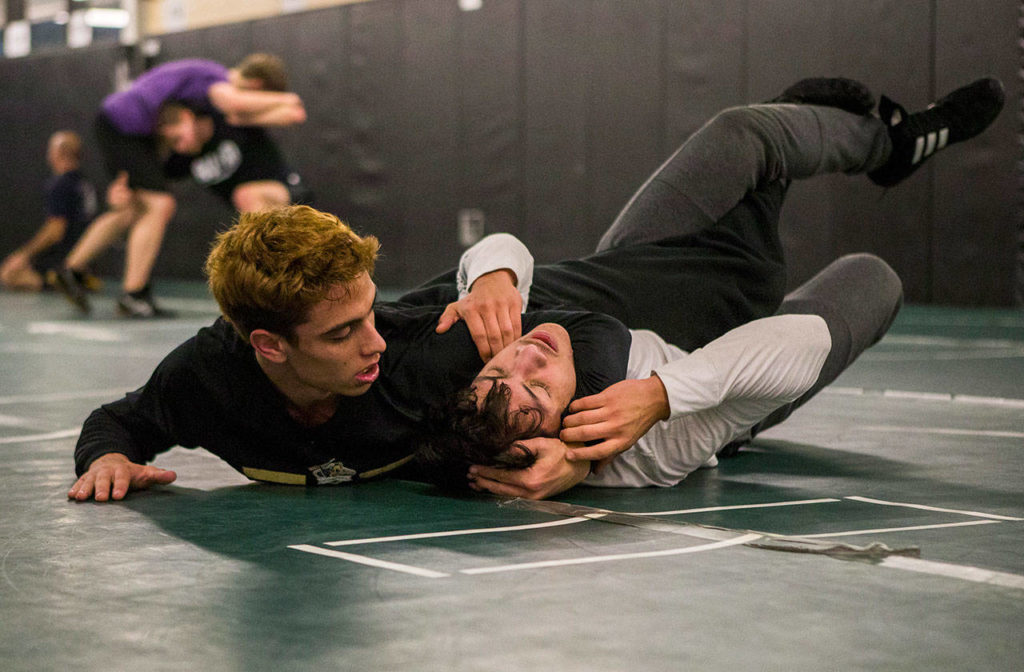 Marysville Getchell’s Trey Padgett puts training partner Jesus Cabadas in a headlock during a team practice Dec. 11 in Marysville. (Olivia Vanni / The Herald)
