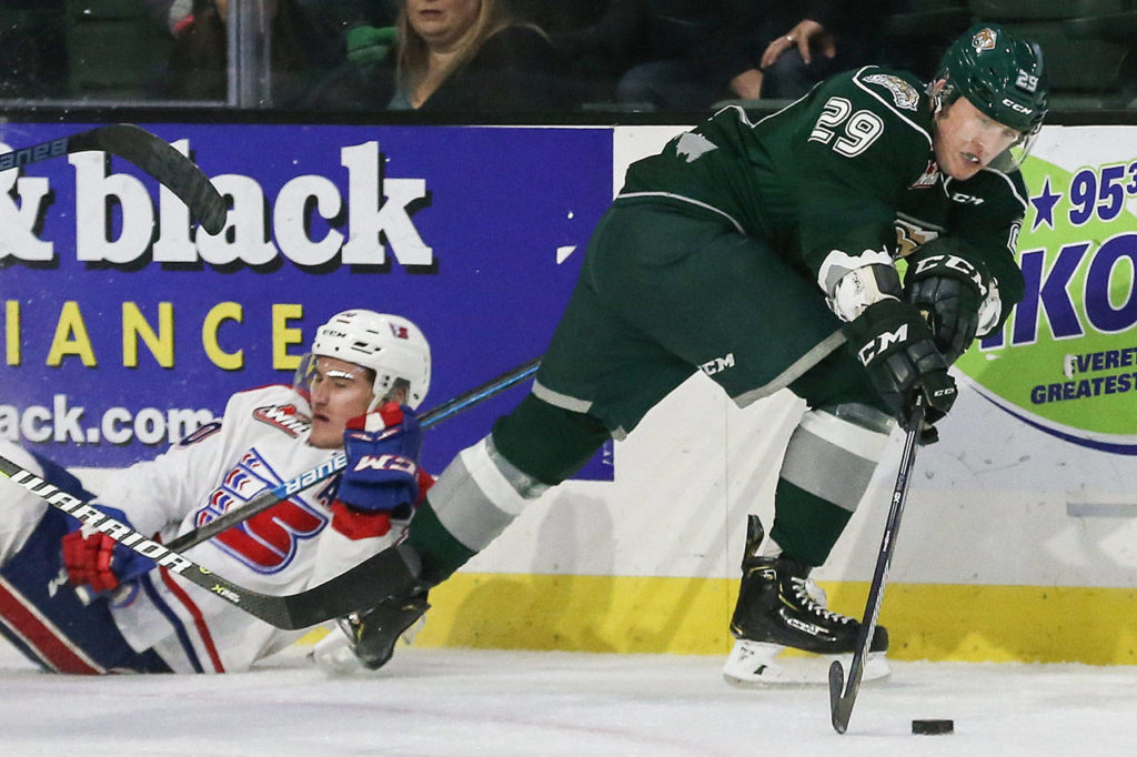 Silvertips Wyatts Wylie (right) controls the puck with Chiefs Ethan McIndoe trailing Sunday night at Angel of the Winds Arena in Everett on December 9, 2018. Silvertips won 2-0. (Kevin Clark / The Herald)
