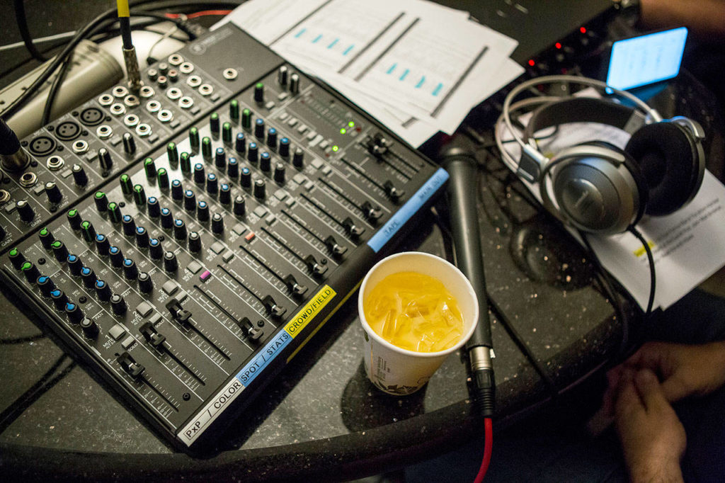 Maury Eskenazi’s drink sits next to a sound board during the annual DUI show at the KRKO radio office in Everett. (Olivia Vanni / The Herald)
