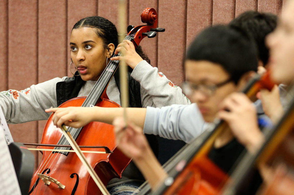 Betty Gebretsadik (left) plays the cello during a recording session at Edmonds Community College. (Kevin Clark / The Herald)
