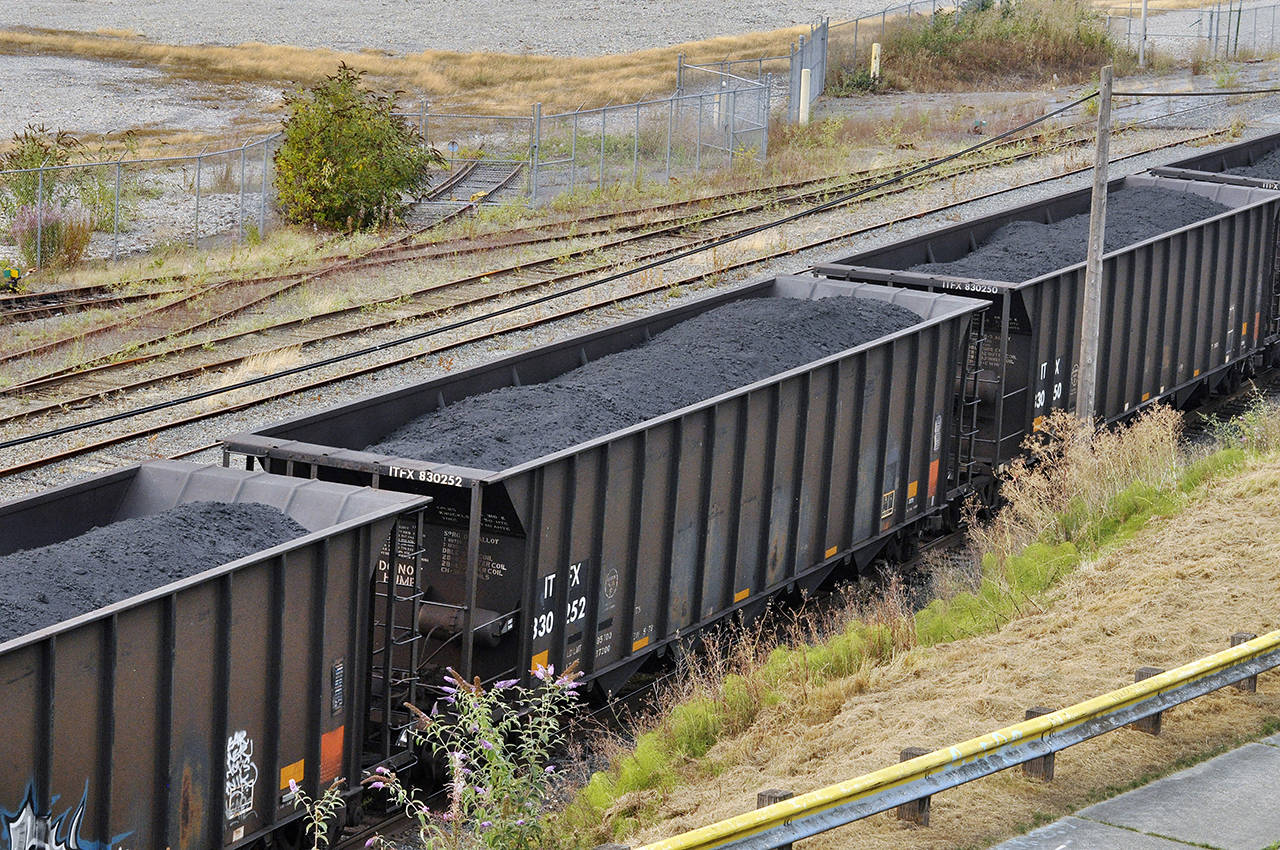Railroad cars filled with coal pass through Everett on Aug. 20. (Sue Misao / Herald file)
