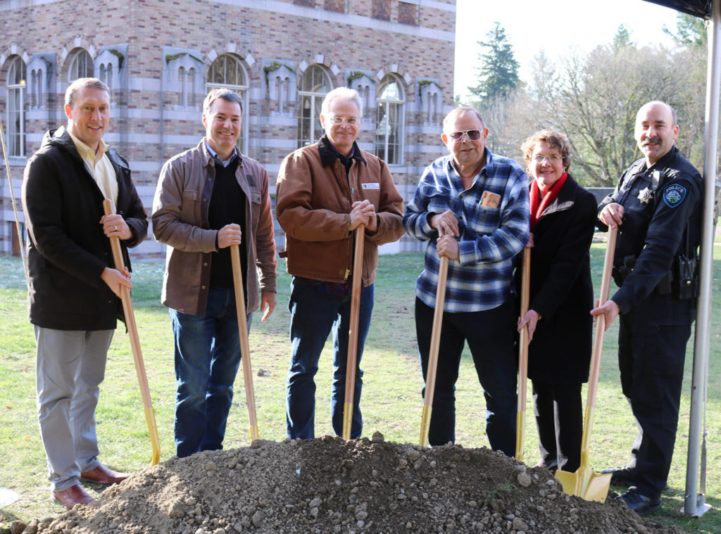 Kenmore city staff, including City Manager Rob Karlinsey, Assistant City Manager Nancy Ousley, Police Chief Peter Horvath, smile with Kevin Daniels and Mayor David Baker at the ceremonial groundbreaking for the Lodge at Saint Edward Park on Dec. 7. (Katie Metzger / Bothell-Kenmore Reporter)
