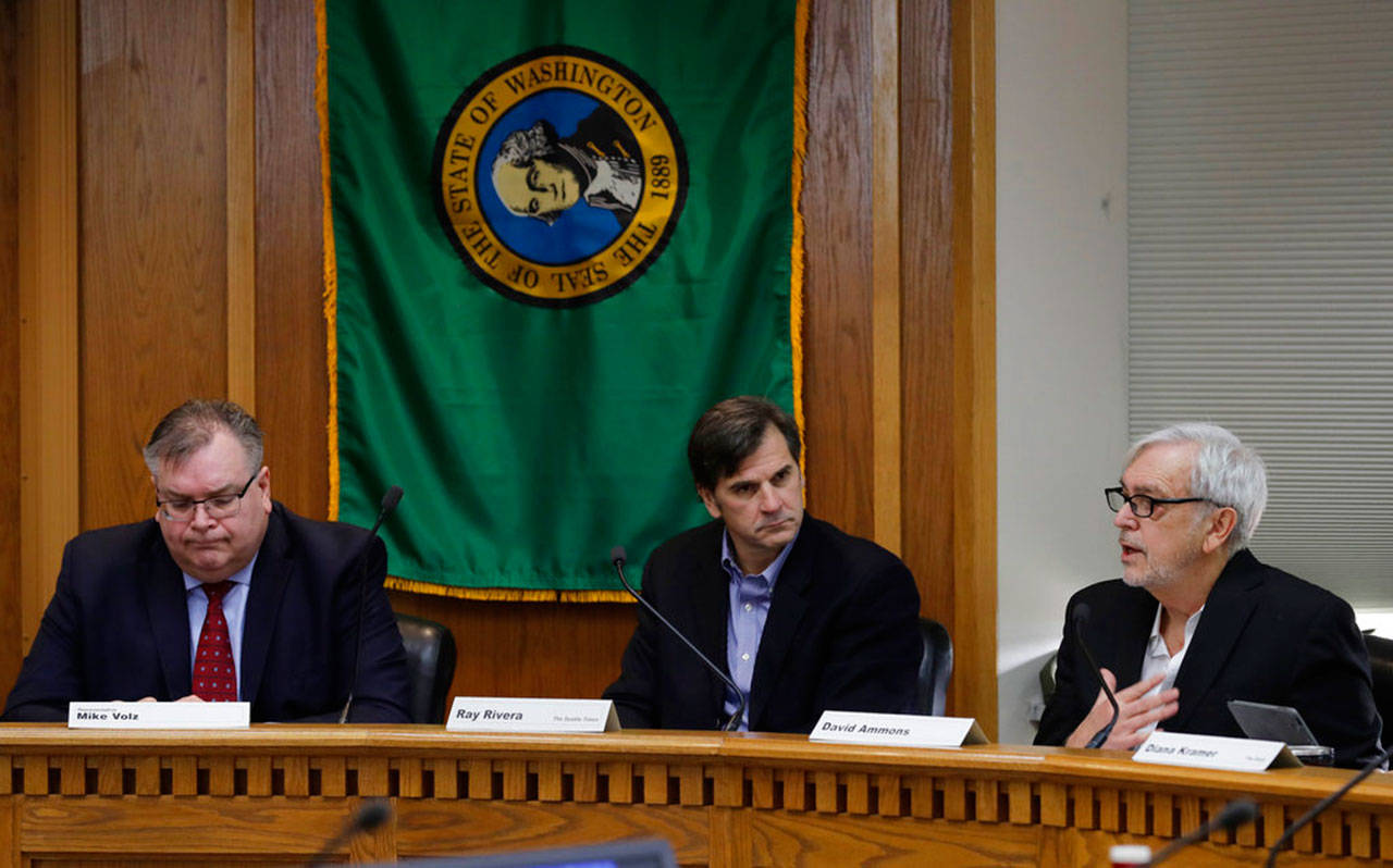 David Ammons, vice chairman of the state Public Disclosure Commission, (right) speaks during the final work session of the Legislative Task Force on Public Records, Dec. 7, at the Capitol in Olympia, as Rep. Mike Volz, R-Spokane (left) and Ray Rivera, deputy managing editor for investigations and enterprise at The Seattle Times, look on. The panel was formed after a lawsuit produced a ruling that state legislators are subject to Washington state’s public records law. (Ted S. Warren/Associated Press)