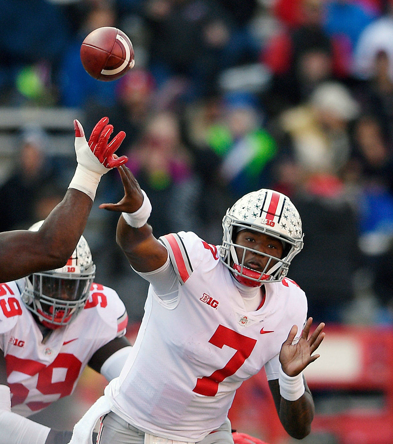 Ohio State quarterback Dwayne Haskins Jr. passes under pressure from a Maryland defender during the second half of a Nov. 17 game in College Park, Md. (AP Photo/Nick Wass, File)